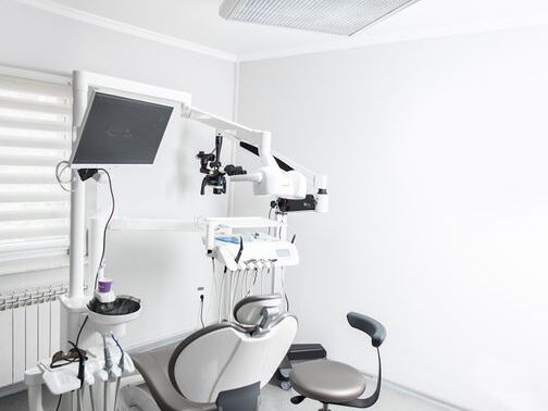 Bright dental clinic room with advanced equipment and a dental chair