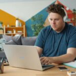 Person using a laptop and headphones for online learning