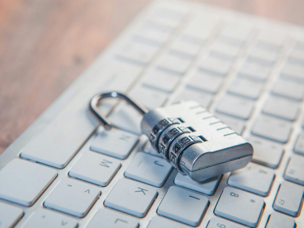 Combination lock on a computer keyboard representing confidentiality