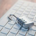 Combination lock on a computer keyboard representing confidentiality